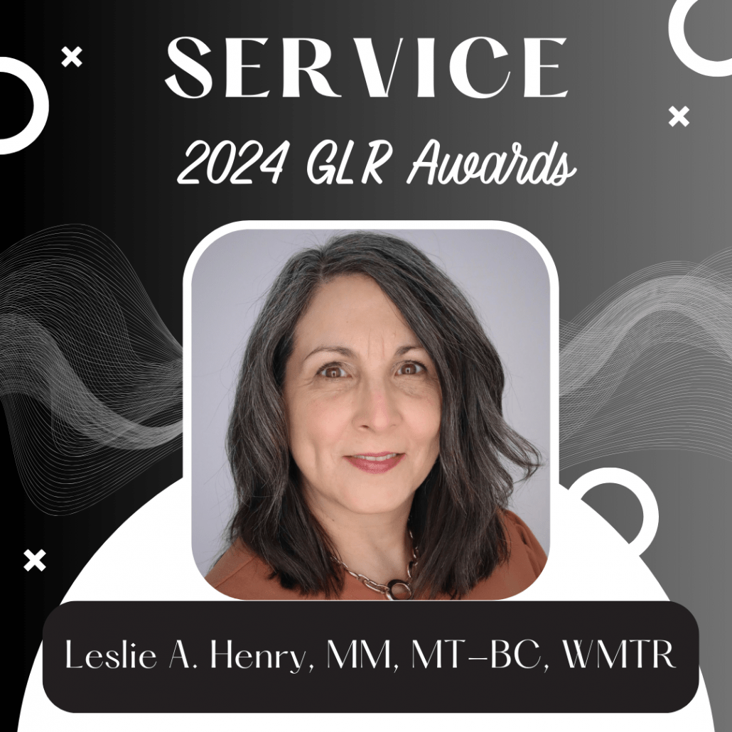 Left to right black fading to grey background with white Xs and Os scattered throughout and a white semicircle at the bottom. The text at the top reads "Service" and "2024 GLR Awards." There is a headshot of a woman with shoulder length hair and a rust shirt below the text. Below the picture is a black box with white text "Leslie A Henry, MM, MT-BC, WMTR"